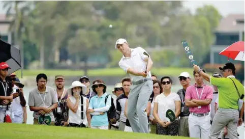  ??  ?? SINGAPORE: This handout photo taken and released by Lagardere Sports on January 29, 2016 shows Jordan Spieth of the US playing a shot during round two of the Singapore Open at the Sentosa Golf Club. — AFP