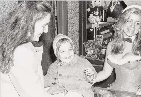  ?? Photo by Kip Norton / Courtesy of YouHere Production­s ?? Belinda Norton and one of her children with a Playboy bunny, in a photo by Kip Norton during a visit to a Playboy Club in New Jersey years ago.