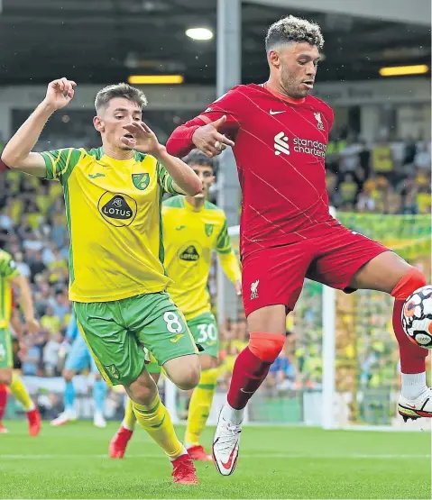 ??  ?? Billy Gilmour on his Premier League debut for Norwich City, up against Alex Oxlade-chamberlai­n of Liverpool