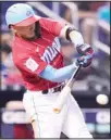  ??  ?? Miami Marlins’ Miguel Rojas hits an RBI-single to score Jesus Sanchez during the sixth inning of a baseball game against the Atlanta Braves, on July 11, in Miami. (AP)