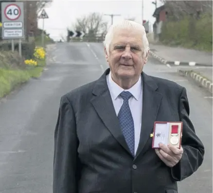  ??  ?? Service to community: Norman Crooks with his British Empire Medal