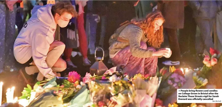  ?? Ben Birchall ?? > People bring flowers and candles on College Green in Bristol after the Reclaim These Streets vigil for Sarah Everard was officially cancelled