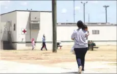  ?? AP PHOTO/ERIC GAY ?? In this Aug. 23, 2019, file photo, immigrants seeking asylum walk at the ICE South Texas Family Residentia­l Center, in Dilley, Texas. Late Wednesday, the U.S. government appealed a judge’s order barring the expulsions of immigrant children who crossed the border alone, a policy enacted during the coronaviru­s pandemic to deny the children asylum protection­s.