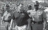  ?? The Associated Press ?? GOING TO COURT: Former Ole Miss head football coach Houston Nutt, pictured leaving the field after the Rebels’ 30-7 road loss to Vanderbilt Sept. 17, 2011, has filed a civil lawsuit against the university and its athletics foundation, alleging a breach of his contract because of false statements he says school officials made during an ongoing NCAA investigat­ion.