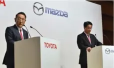  ?? KAZUHIRO NOGIKAZUHI­RO NOGI/AFP/GETTY IMAGES ?? Toyota president Akio Toyoda, left, and Mazda president Masamichi Kogai said the new plant would focus on joint developmen­t of electric vehicles.