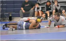  ?? PHOTOS BY ROB WORMAN ?? North Point’s Elijah Griggs works toward a pin in one of his matches at the Warriors Duals last weekend at La Plata High School. Griggs went 5-3 during the two-day event while competing at 170 pounds for the Eagles, who were 2-6 at the tournament.