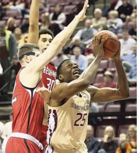  ?? STEVEN CANNON AP ?? FSU’s Mfiondu Kabengele goes up for a shot against Southeast Missouri's Mark Laros, left, during Monday night’s game in Tallahasse­e. Kabengele finished with nine points.