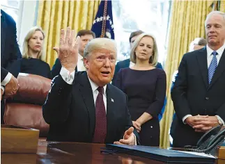  ?? AP Photo/Evan Vucci ?? ■ President Donald Trump answers a reporter’s question about the investigat­ion of special counsel Robert Mueller during a signing ceremony of the “Cybersecur­ity and Infrastruc­ture Security Agency Act” on Friday in the Oval Office of the White House in Washington.