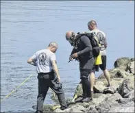  ?? New York State Police ?? State Police and others were at the scene of the recovery of a car in the Hudson River with human remains inside on July 8 in Poughkeeps­ie. The car reportedly belonged to Rohan Stefon Brown, who disappeare­d in August 2008.