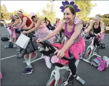  ?? Dan Watson/The Signal ?? (Above) Leslie Payton, right, joins dozens of participan­ts at the annual Henry Mayo Ride for a Cure event Friday. (Below) Tuan Nguyen takes a drink during his two-hour ride Friday at the Ride for a Cure event.