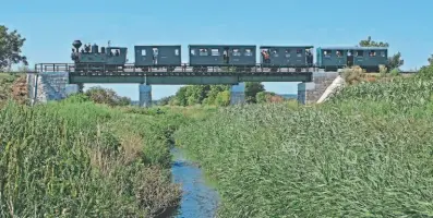  ?? JAMES WAITE ?? Looking good: Former colliery locomotive András crosses a stream with a Nagycenk Museum Railway train in Hungary on August 18, 2019. The 1924-built 0-8-0T is a crowd-puller on the museum’s 2ft 6in gauge line, which steam enthusiast James Waite describes as a “hidden gem.”