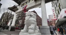  ?? NANCY LANE / HERALD STAFF FILE ?? ‘WORK TOGETHER’: The Chinatown Gate is seen hours after a shooting on Sunday in Boston.