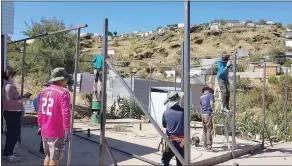  ?? ?? Revamping… Volunteers erecting a shack for one of the residents.