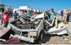  ?? AFP ?? Flattened People survey a destroyed car in Ciudad Acuna, Mexico. Walls and ceilings collapsed under the force of the tornado, which blew gusts over 200km/h.