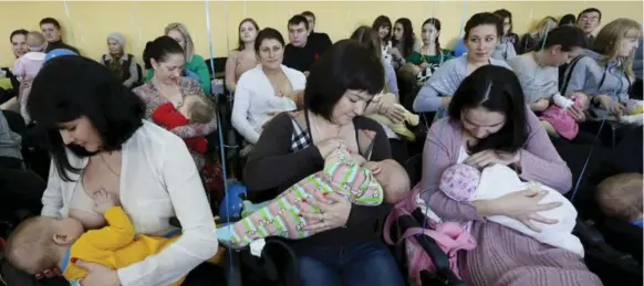  ?? ILYA NAYMUSHIN/REUTERS ?? Mothers nurse their babies during a “flash mob” at a clinic in Krasnoyars­k, Russia, during an annual week to promote breastfeed­ing.