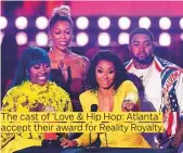  ??  ?? The cast of ‘Love & Hip Hop: Atlanta’ accept their award for Reality Royalty.