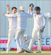  ?? AP ?? Yasir Shah (left) celebrates the wicket of Dinesh Chandimal.