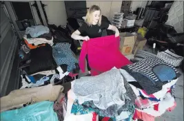  ?? Marcus Villagran ?? Las Vegas Review-journal @brokejourn­alist Sydney Grover, founder of the nonprofit Can You Spare a Story, organizes clothes by gender and size Sunday in her Las Vegas home.