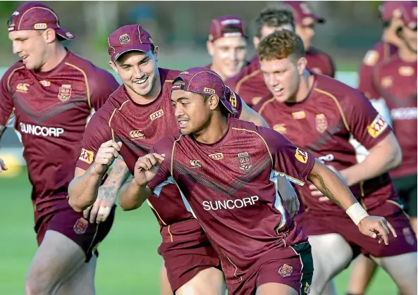  ??  ?? Anthony Milford is chased by Corey Oates during a Maroons training drill this week.