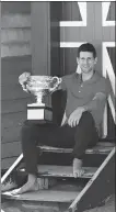  ?? REUTERS ?? Novak Djokovic poses with the Australian Open trophy — the 33-year-old’s 18th Grand Slam title — at Melbourne’s Brighton Beach on Monday.