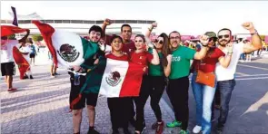  ?? ?? Mexico fans pose outside the Al Bayt Stadium in Al Khor yesterday.