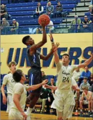  ?? PAUL DICICCO — THE NEWS-HERALD ?? Gilmour’s CJ Charleston shoots over Lake Catholic’s Jack LeJuene (24) on Jan 28 at John Carroll University.