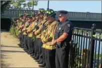  ??  ?? Troy firefighte­rs and police officers bow their heads as they pray during a memorial ceremony Monday to mark the 16th anniversar­y of the Sept. 11, 2001, terror attacks.