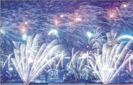  ?? LAM YIK FEI / GETTY IMAGES ?? Midnight fireworks over Victoria Harbour illuminate Hong Kong’s skyline during the city’s New Year celebratio­ns for 2017.