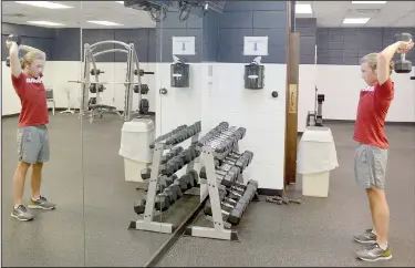  ?? (NWA Democrat-Gazette/Keith Bryant) ?? Evin Davis lifts a dumbbell in an overhead triceps extension in the Riordan Hall fitness center, which opened last week.