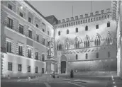  ?? SUSAN WRIGHT/THE NEW YORK TIMES ?? The fortressli­ke home office of Banca Monte dei Paschi in the old quarter of Siena, Italy. The financial institutio­n was founded in 1472.