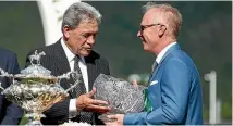  ?? GETTY IMAGES ?? Racing Minister Winston Peters presents Tony Pike with the owners’ trophy yesterday.