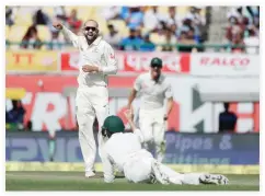  ??  ?? Australia’s Nathan Lyon celebrates the dismissal of India's Cheteshwar Pujara during the second day of their fourth Test cricket match in Dharamsala, India, Sunday. (AP)