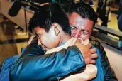  ?? Associated Press file photo ?? David Xol-cholom, of Guatemala, hugs his son Byron as they reunite in January 2020 at Los Angeles Internatio­nal Airport after a year and a half.