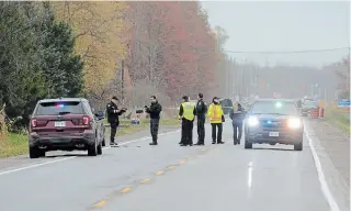  ?? DAVE JOHNSON TORSTAR FILE PHOTO ?? Police collision reconstruc­tion unit members and forensics officers look over part of a crash scene in Pelham in October. A charge has been dropped against a motorist in relation to the crash.