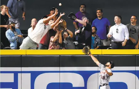  ?? Norm Hall / Getty Images ?? Balls are leaving the ballpark at a startling rate this season, including, above, one hit by Arizona’s Brandon Drury over the glove of Detroit’s Tyler Collins in May. Many pitchers say the baseballs are harder and have flatter seams this season.