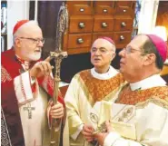  ?? AP FILE PHOTO/PORTLAND PRESS HERALD, GABE SOUZA, POOL ?? From left, Sean Patrick Cardinal O’Malley, Archbishop of Boston; the Most Rev. Carlo Maria Viganò, apostolic nuncio to the United States, and the Most Rev. Robert Peter Deeley, prepare for the installati­on Mass of Bishop Deeley at the Cathedral of the Immaculate Conception in Portland, Maine, on Feb. 14, 2014.