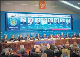  ?? Alexander Nemenov AFP/Getty Images ?? MEMBERS of Russia’s Central Election Commission in Moscow announce preliminar­y results of the presidenti­al election. Vladimir Putin won nearly 77%.