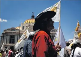  ?? Sashenka Gutierrez European Pressphoto Agency ?? SMALL FARMERS in Mexico City protest government cuts as well as NAFTA, which they say has undermined their livelihood with cheap U.S. food imports.