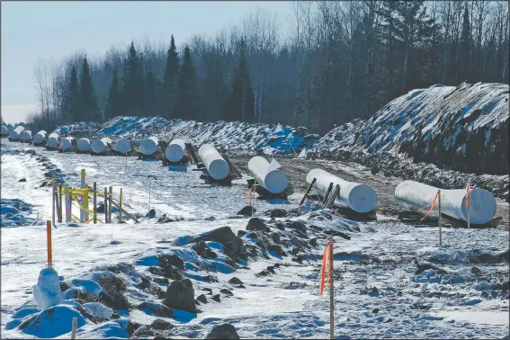  ?? (Indian Country Today/Mary Annette Pember) ?? Sections of pipe await placement near Grand Rapids, Minn., for the Enbridge Line 3 project. Conflict is growing among Indigenous communitie­s along the nearly 400-mile path of Enbridge’s Line 3. As the project cuts across the Fond du Lac reservatio­n, treaty lands of several other bands of Ojibwe, and the headwaters of the Mississipp­i River in northern Minnesota, it has brought not just jobs but controvers­y and discord into the most intimate spheres of spirituali­ty, family, and community.