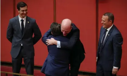  ?? Photograph: Mike Bowers/The Guardian ?? ‘Rainbow rebels’: Trevor Evans and Tim Wilson look on as Trent Zimmerman congratula­tes Dean Smith during the first reading of his marriage equality bill in the Senate in 2017.