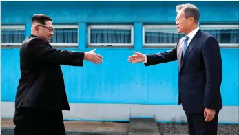  ?? PICTURE: AP/AFRICAN NEWS AGENCY (ANA) ?? North Korean leader Kim Jong-un, left, prepares to shake hands with South Korean President Moon Jae-in over the military demarcatio­n line at the border village of Panmunjom in the demilitari­zed zone yesterday. Kim is the first North Korean leader since...