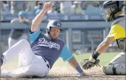  ?? Victor Decolongon Getty Images ?? MAX MUNCY scores past Padres catcher Austin Hedges on Justin Turner’s hit in the eighth inning.