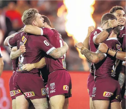  ??  ?? Victors and vanquished . . . Queensland players celebrate winning game one of the 2020 State of Origin s