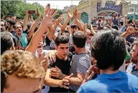  ?? AP ?? Protesters chant slogans at the main gate of the Old Grand Bazaar in Tehran on Monday. —