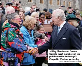  ?? Hollie Adams/Press Associatio­n ?? King Charles and Queen Camilla meet members of the public outside St George’s Chapel in Windsor yesterday