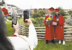 ??  ?? Left: Shu Saw (right) and Benjamin Liang of Washington High School pose for pictures after their ceremony.