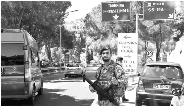  ??  ?? File photo shows Italian soldiers controling the access to the city of Taormina in Sicily. — AFP photo