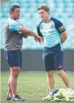  ??  ?? Waratahs coach Daryl Gibson talks to captain Michael Hooper.