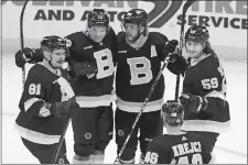  ?? MICHAEL DWYER/AP PHOTO ?? Boston Bruins players David Pastrnak (88) celebrates his goal with Dmitry Orlov (81), Charlie McAvoy (73), Tyler Bertuzzi (59) and David Krejci (46) during the third period of a game against the New York Rangers on March 4, in Boston.