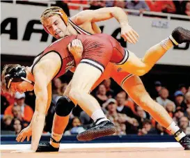  ?? [PHOTO BY NATE BILLINGS, THE OKLAHOMAN] ?? Oklahoma State’s Joe Smith, back, is keeping a family tradition alive by qualifying for the NCAA Wrestling Tournament. The son of Cowboys coach John Smith has attended the tournament since age 7.